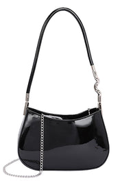 Black patent leather handbag with a chain detail on a white background